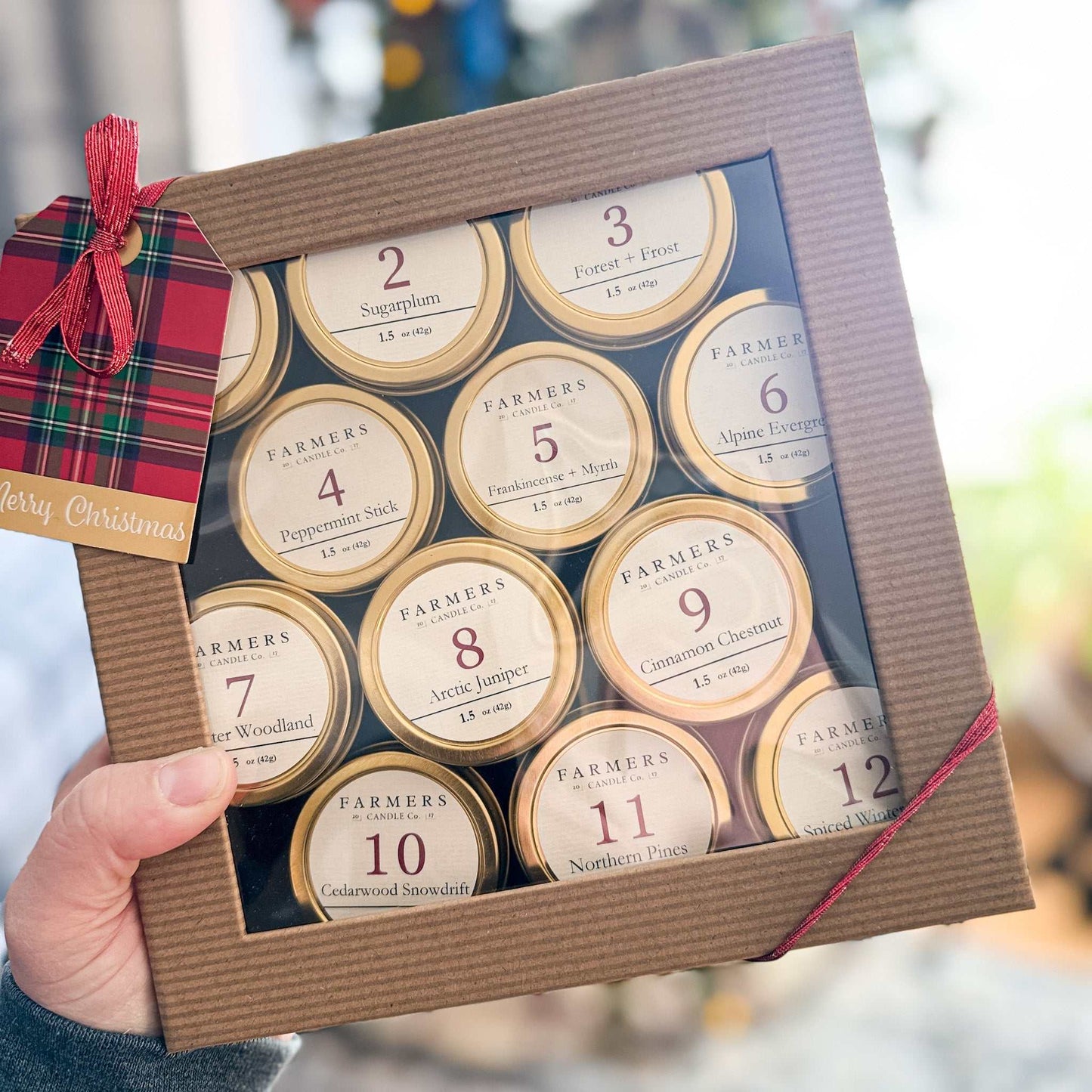 12 Days of Scented Holiday Cheer gold tin candle gift set with twelve 1.5 oz candles and kraft gift box