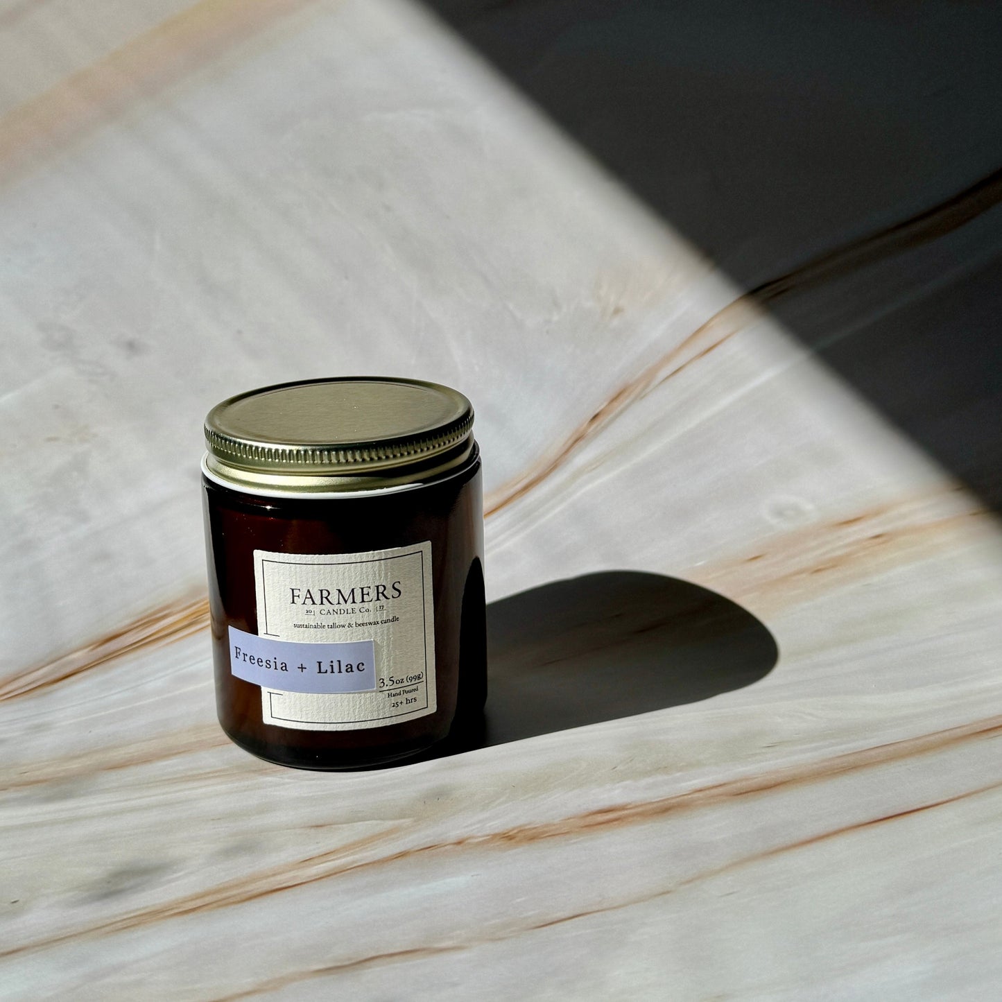 Freesia and lilac floral candle with fresh green leaves and sugared peach aroma